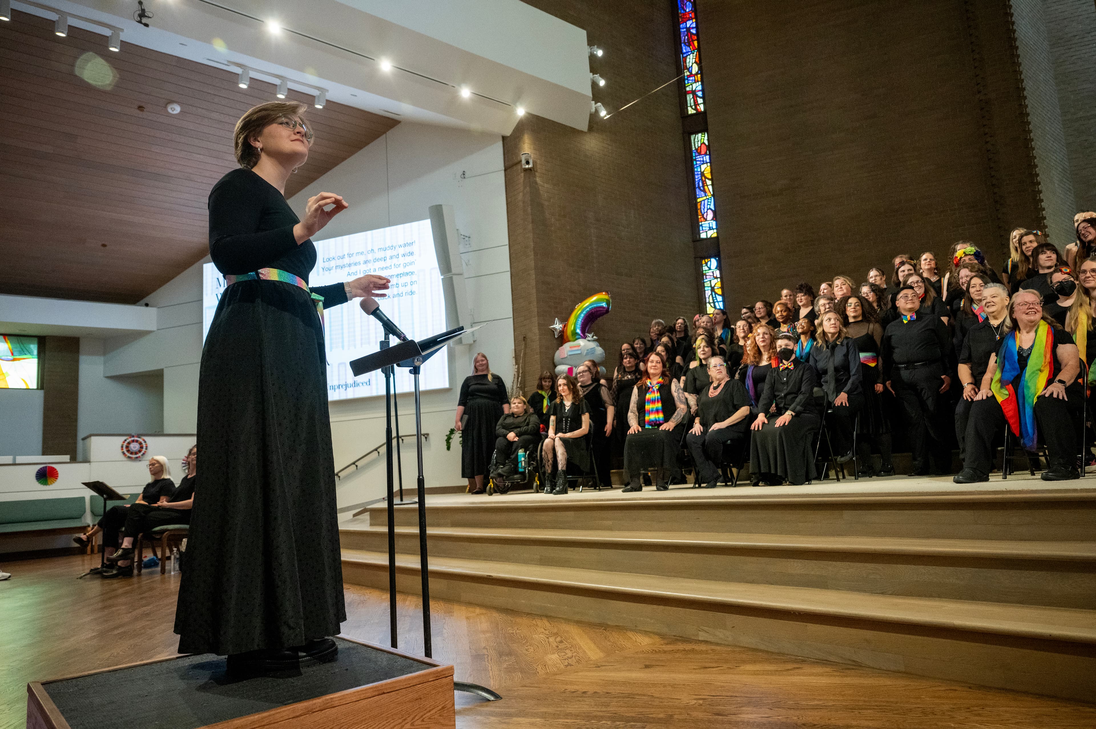 Hannah Kimball conducting a choir